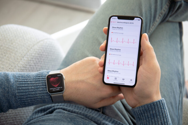 Person looking at app on phone tracking heart rate and rhythm.
